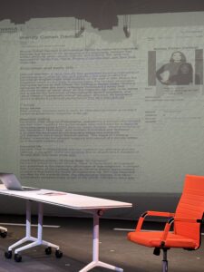 A projection in the background of the set showing the Wikipedia Article of the real life Wendy