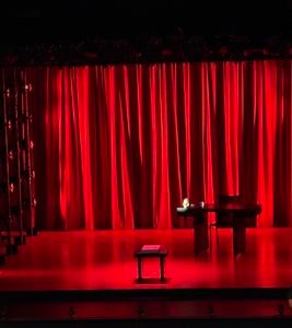The show's minimalistic set. The sparsity is made ominous with the presence of strong red lighting